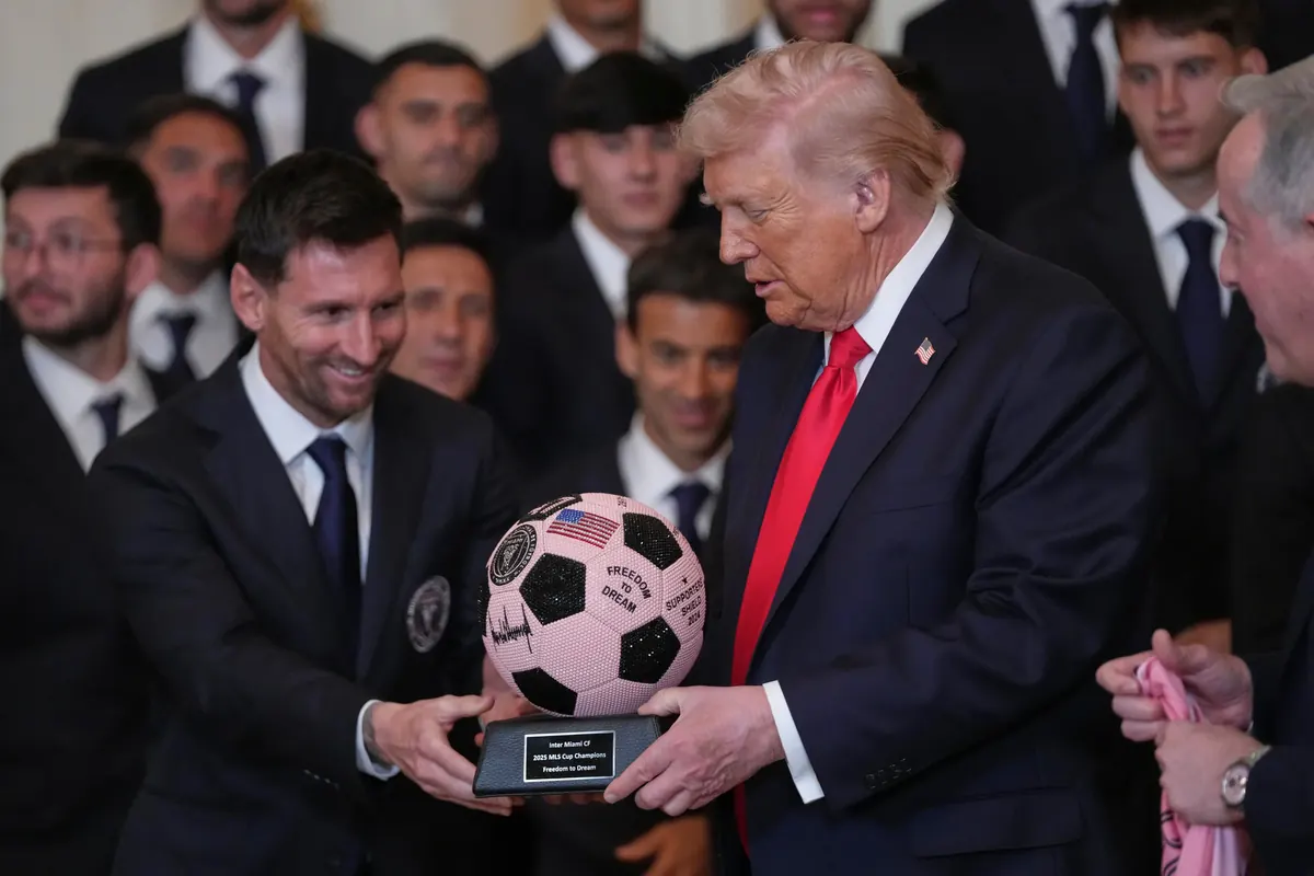 Lionel Messi presenting a pink soccer ball to President Donald Trump during Inter Miami MLS Cup White House ceremony
