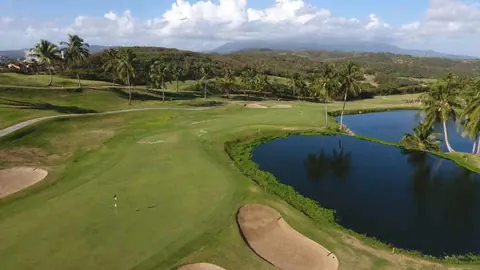 Scenic oceanfront golf course in Puerto Rico with palm trees and Caribbean coastline views