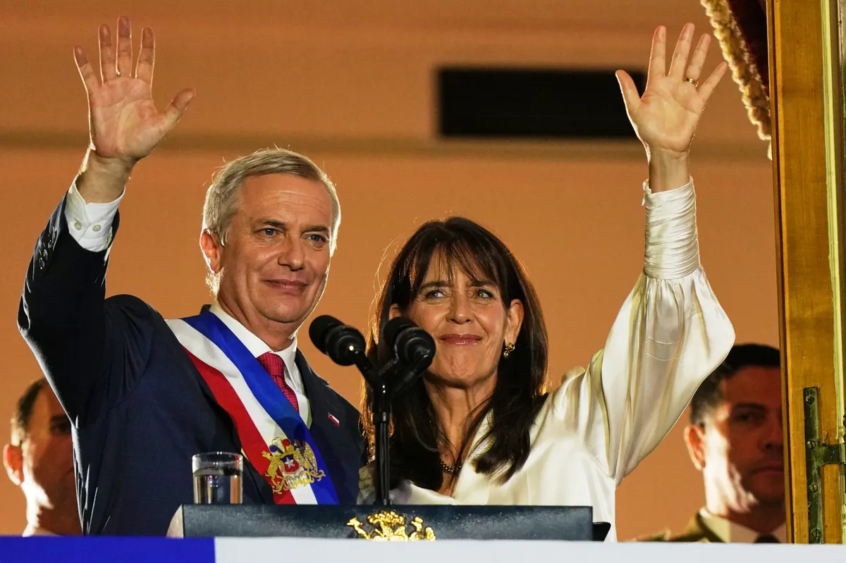 Chile’s President Jose Antonio Kast and his wife Maria Pia Adriasola wave to supporters from the balcony of La Moneda presidential palace after his inauguration in Santiago, Chile, Wednesday, March 11, 2026.