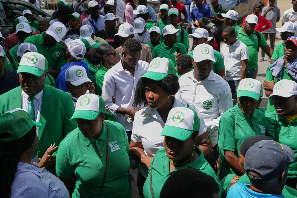Supporters of Haitian political parties gather outside the Provisional Electoral Council headquarters during election registration