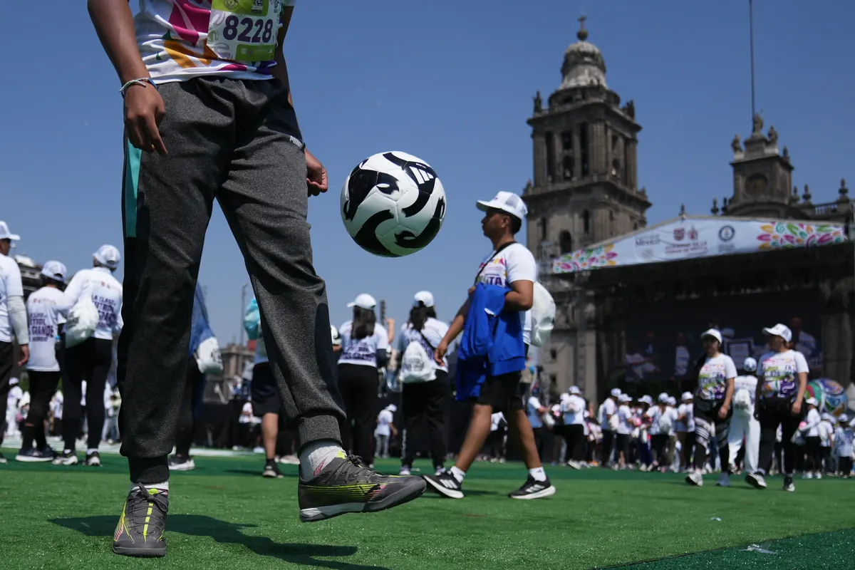 Thousands of participants practicing soccer drills at Mexico City’s Zócalo during the world record soccer class event.