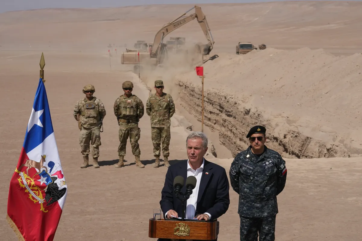 Bulldozer digging trench at Chile northern border as part of immigration control project