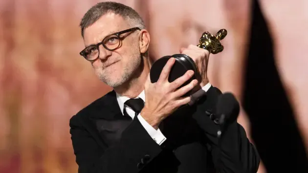 Paul Thomas Anderson holding Oscar for Best Director at Academy Awards ceremony