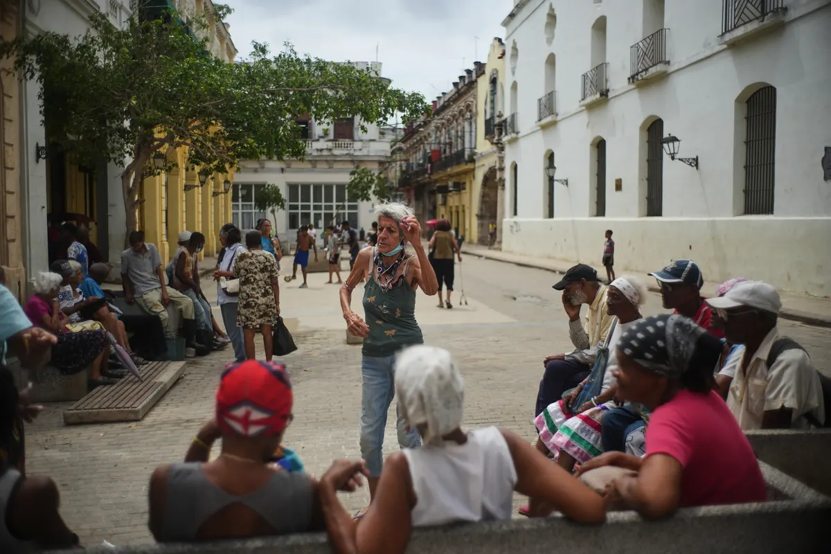A women dance as she waits to eat meal, during blackout in Havana