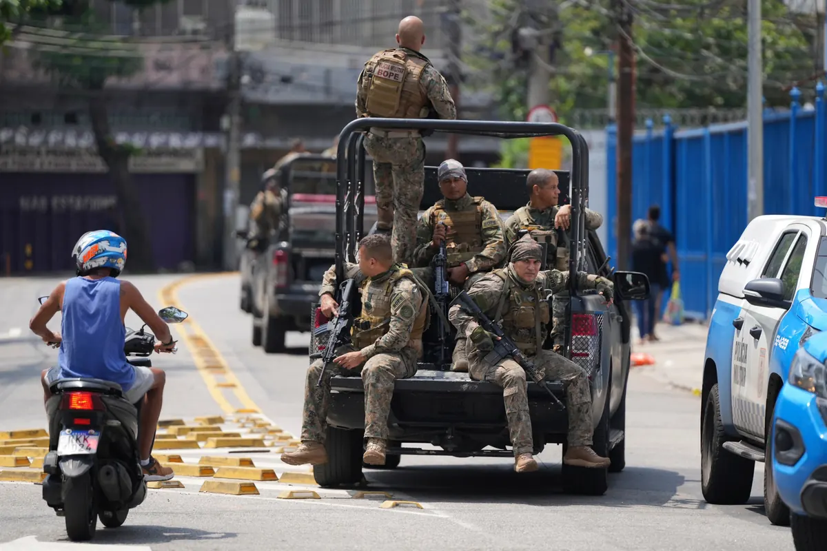 Brazilian police operation in Rio favela with officers and armoured vehicles during raid
