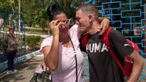 Families reuniting with released prisoners outside Havana prison gates